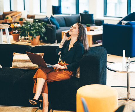 Businesswoman working in coworking. Happy businesswoman talking on the phone in modern Office. Business concept.