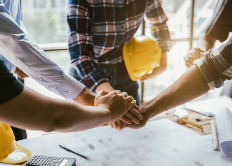 construction worker and contractor. Client shaking hands with team builder in renovation site in the morning.