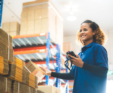 warehouse worker using bar code scanner to scanning box and analyze newly arrived goods for further placement in storage department, Working at warehouse.